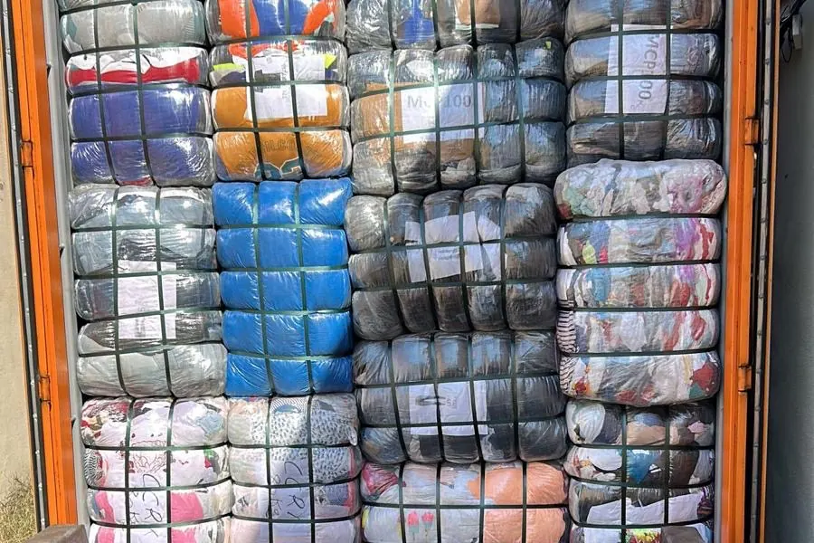 Open container fully loaded with strapped clothing bales