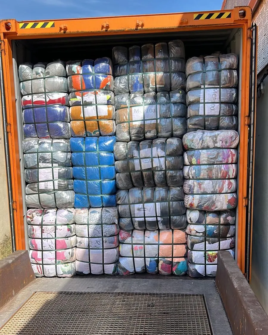 Open container fully loaded with strapped clothing bales